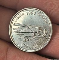 Reverse showing airplane design, year and month inscription