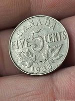 Reverse side showing CANADA, 5 Cents, maple leaves, date 1933