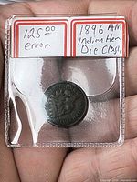 Coin in labeled 2×2 flip showing packaging and handwritten details