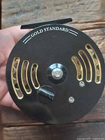 Front face of reel showing Gold Standard branding and black faceplate