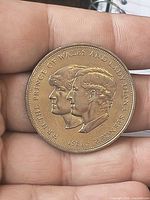 Gold-tone coin obverse with double portrait and 1981 date