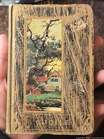 Front cover showing illustrated onlay and gilt decoration