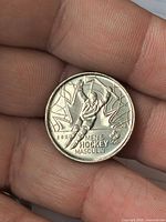 Reverse of coin showing Men's Hockey design and Olympic logo