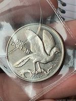Obverse of coin showing bird and ONE DOLLAR inscription