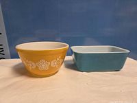 Front view of both Pyrex pieces: turquoise butter dish base and harvest gold floral bowl