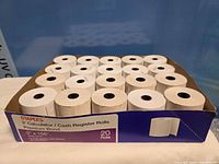 Open Staples carton containing 20 white paper rolls