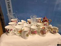 Overall lot showing china mugs, teapot set and glass pitchers