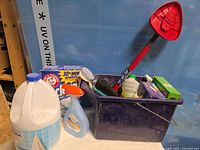 Overall view of pail with cleaning products
