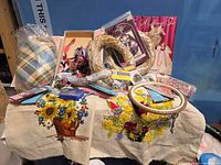 overview of lot showing straw wreaths, fabric panel, hoop, patterns, ribbons