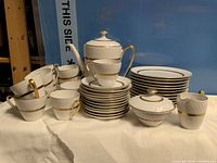 Full set grouped: teapot, sugar bowl, cups, saucers, plates