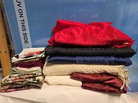 Stack of assorted large linens and smaller folded pieces