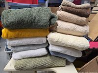 Two vertical stacks showing variety of towel colors and sizes