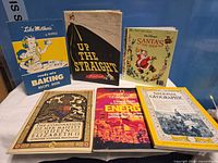 All six publications arranged upright and flat to show covers