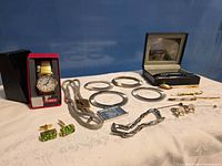 Overview of all jewellery items including Timex watch, bolo tie, bangles, cufflinks, bracelets, tie bars, spoon pin, pendant and Citizen box