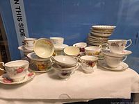 Front view of assorted teacups, saucers and plate stack