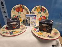 All items: four plates, two boxed mugs, boxed cheese grater