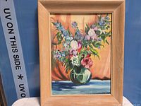 Front view of framed floral acrylic painting