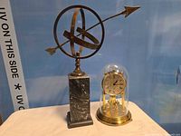 Armillary sphere and Kundo clock side by side full view