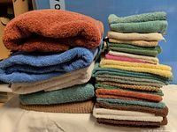 Stacks of assorted towels various sizes and colours