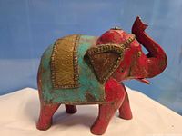 Left side view showing paint colors, metal saddle, carving details