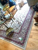 Full view of rug on hardwood floor with furniture for scale