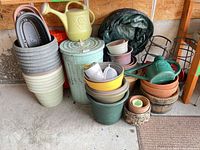 overall lot showing planters, watering can, trash can