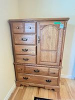 front view of wood highboy dresser showing drawers and cabinet