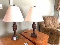 Front view of both matching table lamps with shades on end tables
