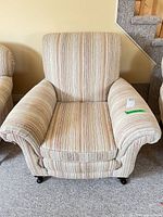 Front view of entire armchair showing upholstery pattern and overall style