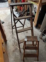 Both wooden ladders side-by-side in garage