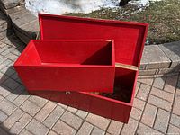 Open red wooden tool chest showing insert tray placed inside