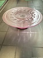 Top angled view of the amethyst glass pedestal cake stand showing bubble pattern and purple tint