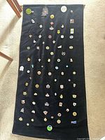 Full view of black velour banner with numerous curling pins attached