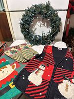 Overall view of wreath, vest, mitts, stocking
