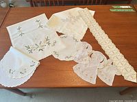 All six Christmas linens laid out on table