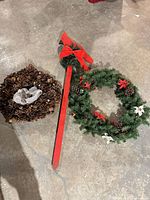 Group shot of pine cone wreath, cardinal stake and evergreen wreath