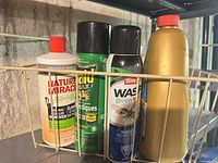 Basket holding Nature's Miracle, Raid Max, Ortho Wasp B Gon, yellow bottle