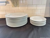 Stacked dinner and salad plates on counter
