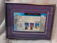 Framed souvenir sheet showing three basketball stamps, matting and frame