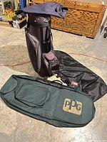 Golf bag standing with two travel covers laid out