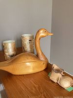 Group view showing two birch design candles, carved wood duck and shoe