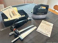Overview of Chef hand mixer on storage case, Cuisinart electric knife handle, two blade sets, instruction booklet