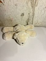 Top view of cream Pottery Barn plush polar bear lying flat