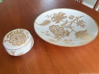 Top view of Heinrich Selb white porcelain platter and matching covered dish showing gold floral decoration