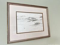 Angled view of framed sketch showing artwork, matting, frame detail