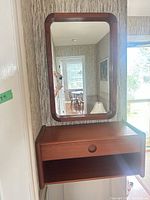 Console and mirror mounted on wall