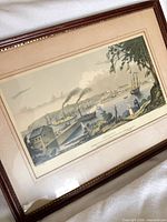 Print showing harbour scene with steamboat, framed under glass