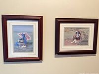 Both framed Amish-themed prints on wall