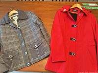 Full view of both jackets laid flat on table