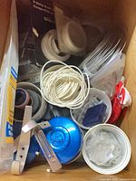 view of drawer with tubs of fasteners, zip ties, hooks, door knob and tape